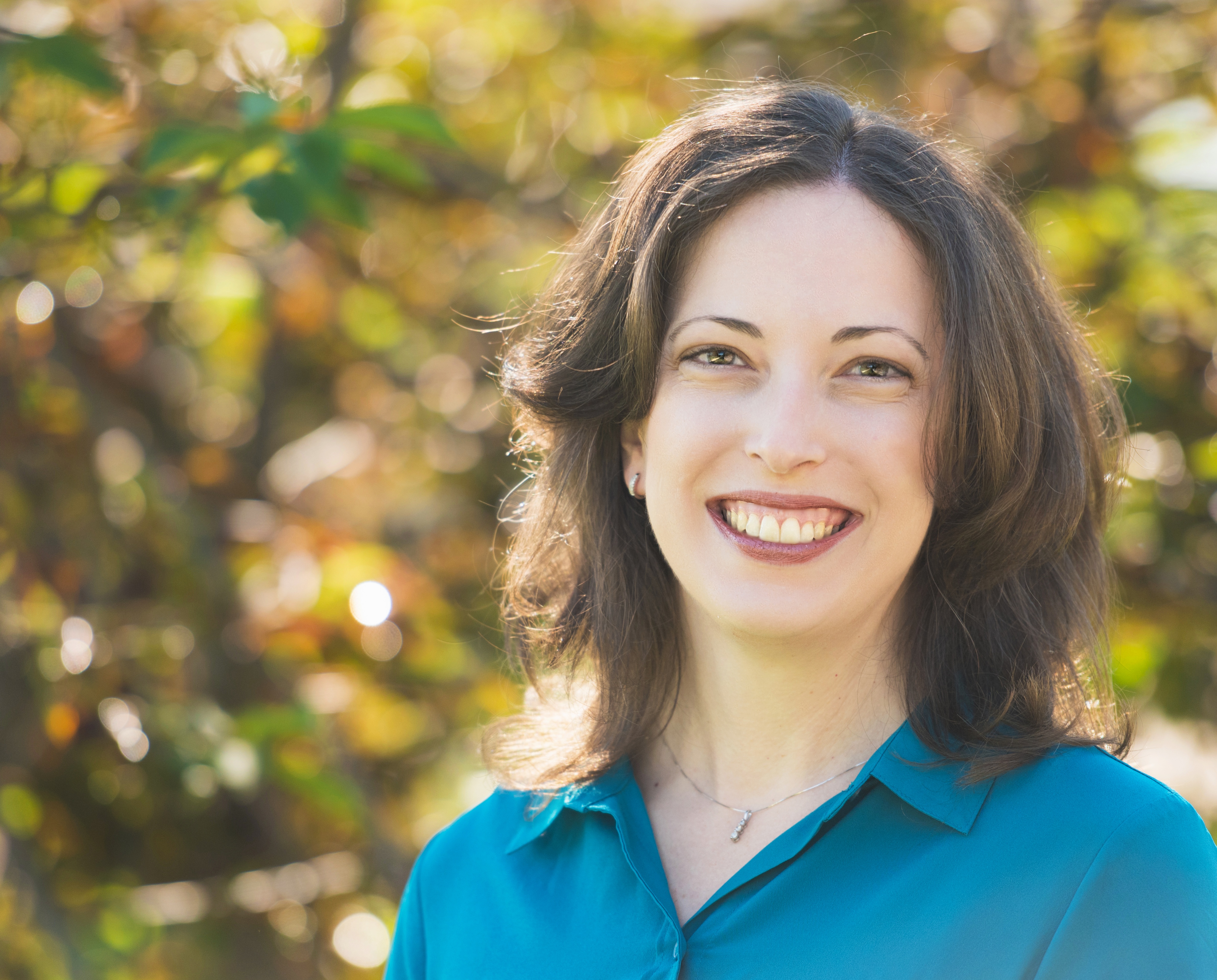 Photograph of Dr. Jennifer Hill.  Dr. Hill is a white female with brown hair.  In the photo she is wearing a blue shirt and smiling at the camera.