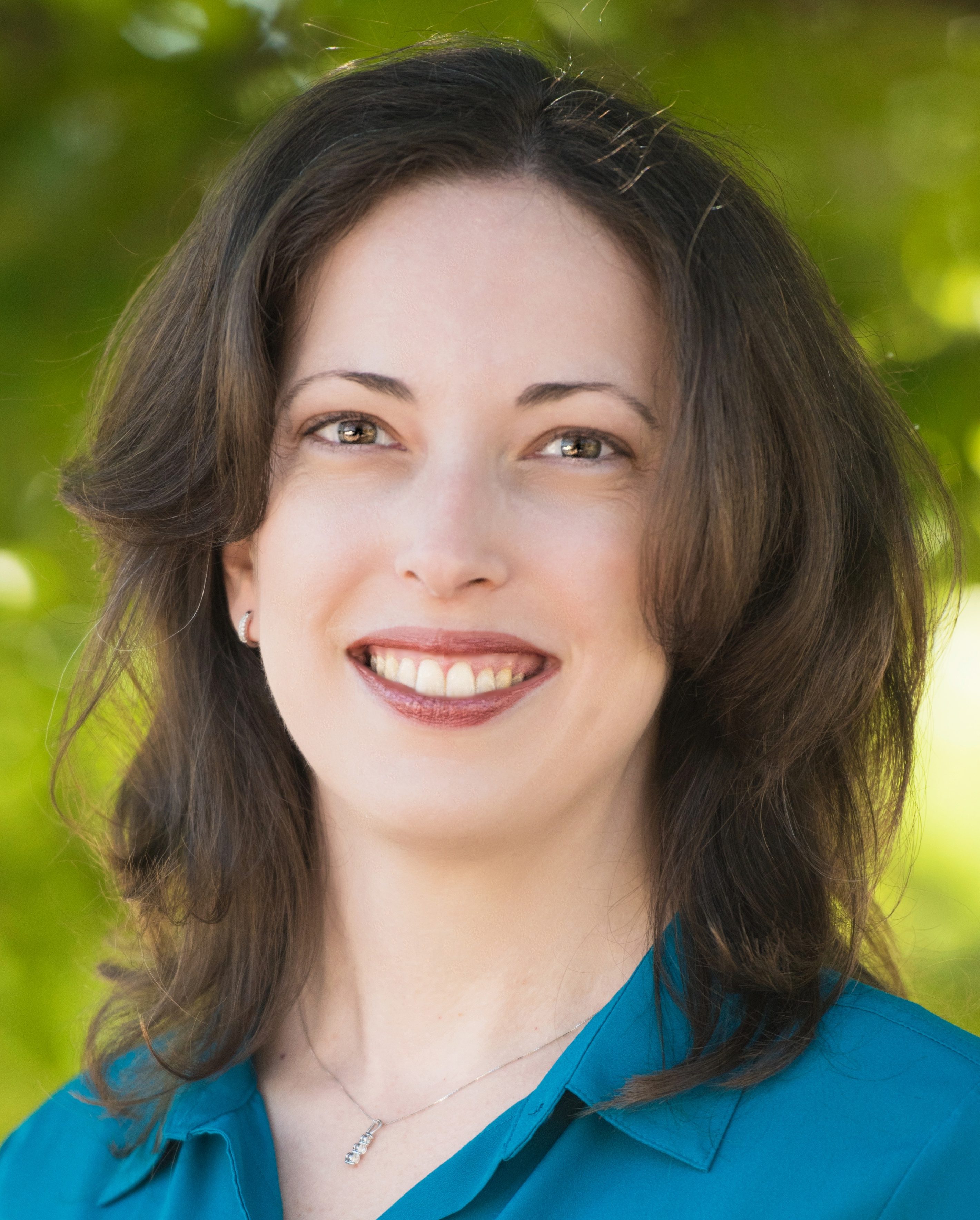 Photograph of Dr. Jennifer Hill. Dr. Hill is a white female with brown hair. In the photo she is wearing a blue shirt and smiling at the camera.